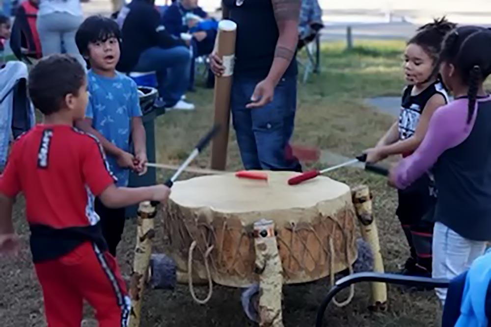 Tribal youth learning how to drum