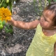 Tribal toddler exploring a garden