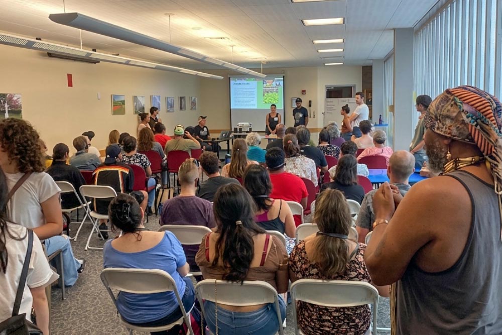 Presenters address a full room of seated community members at a Pocasset Pokanoket Land Trust workshop Pocasset Pokanoket Land Trust Community Workshop Presentation
