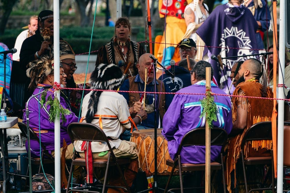 Drum Group Singers at Pocasset Pokanoket Land Trust Powwow Singers in regalia gather around a large drum at a Pocasset Pokanoket Land Trust powwow.